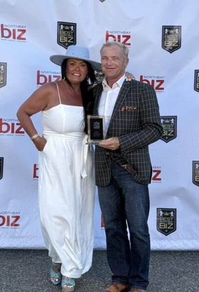 Gary and Shena Harvey Celebrate Wedge Roofing's Gold Medal Award.